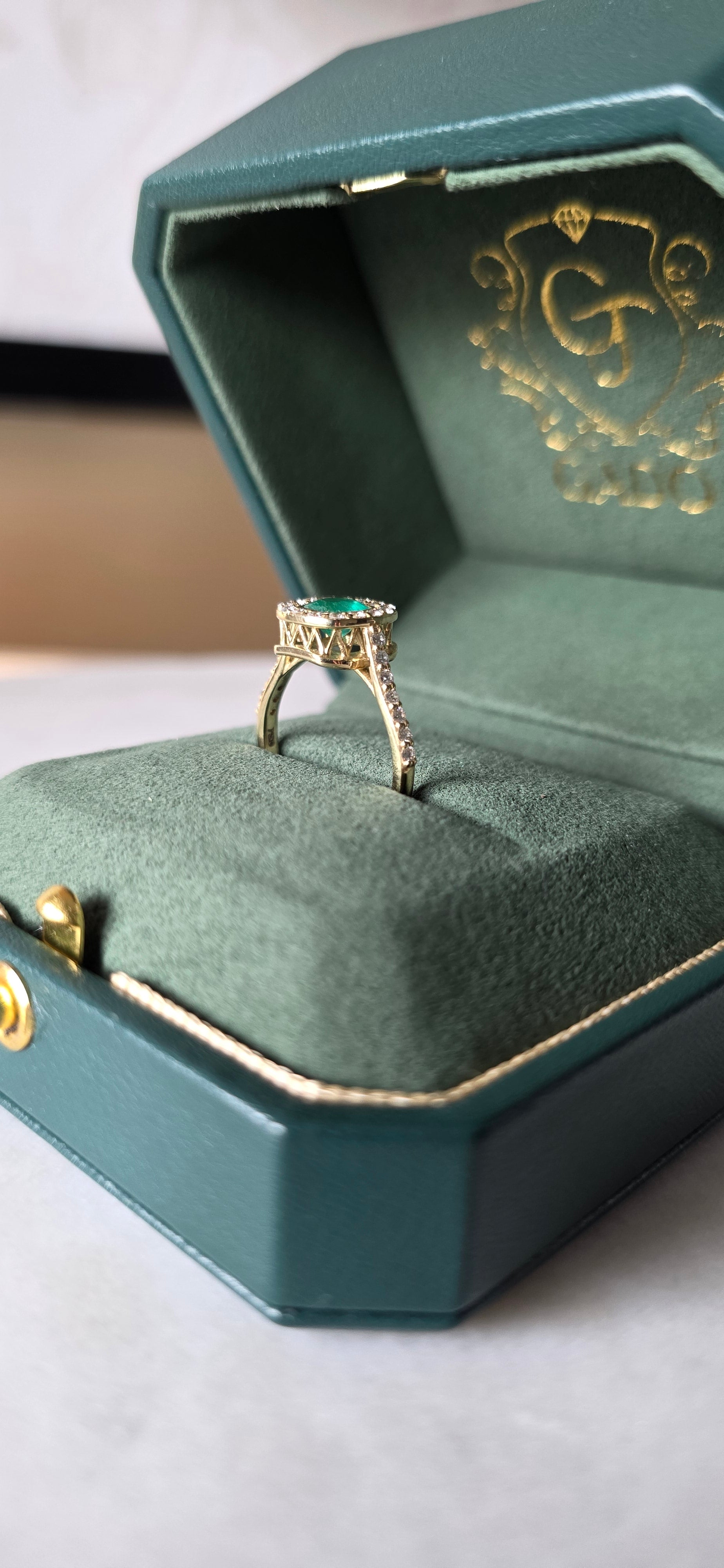 0.62 CT cushion Emerald with diamond halo ring