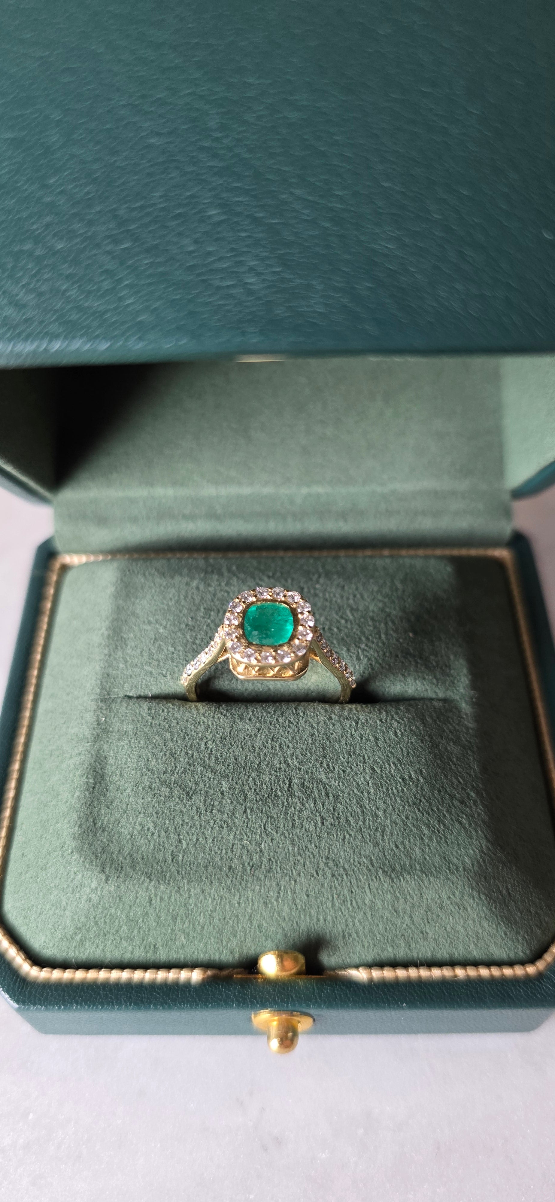 0.62 CT cushion Emerald with diamond halo ring