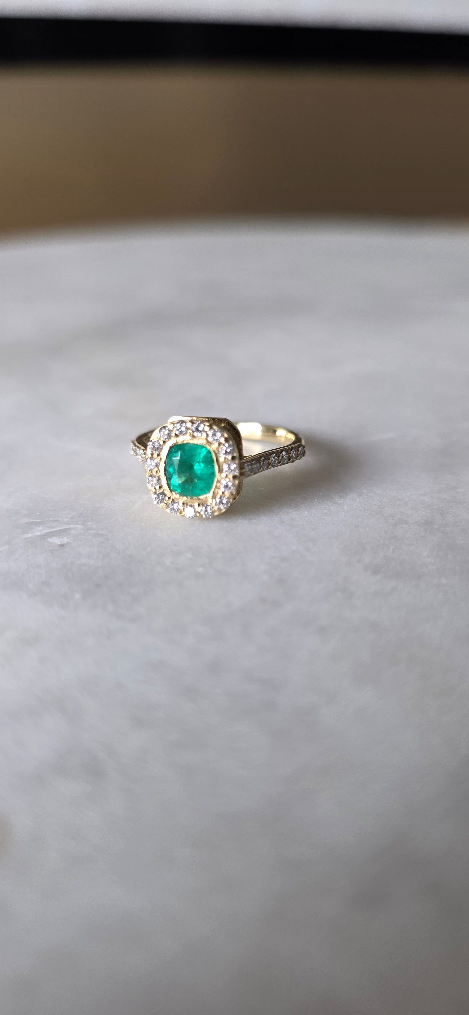 0.62 CT cushion Emerald with diamond halo ring