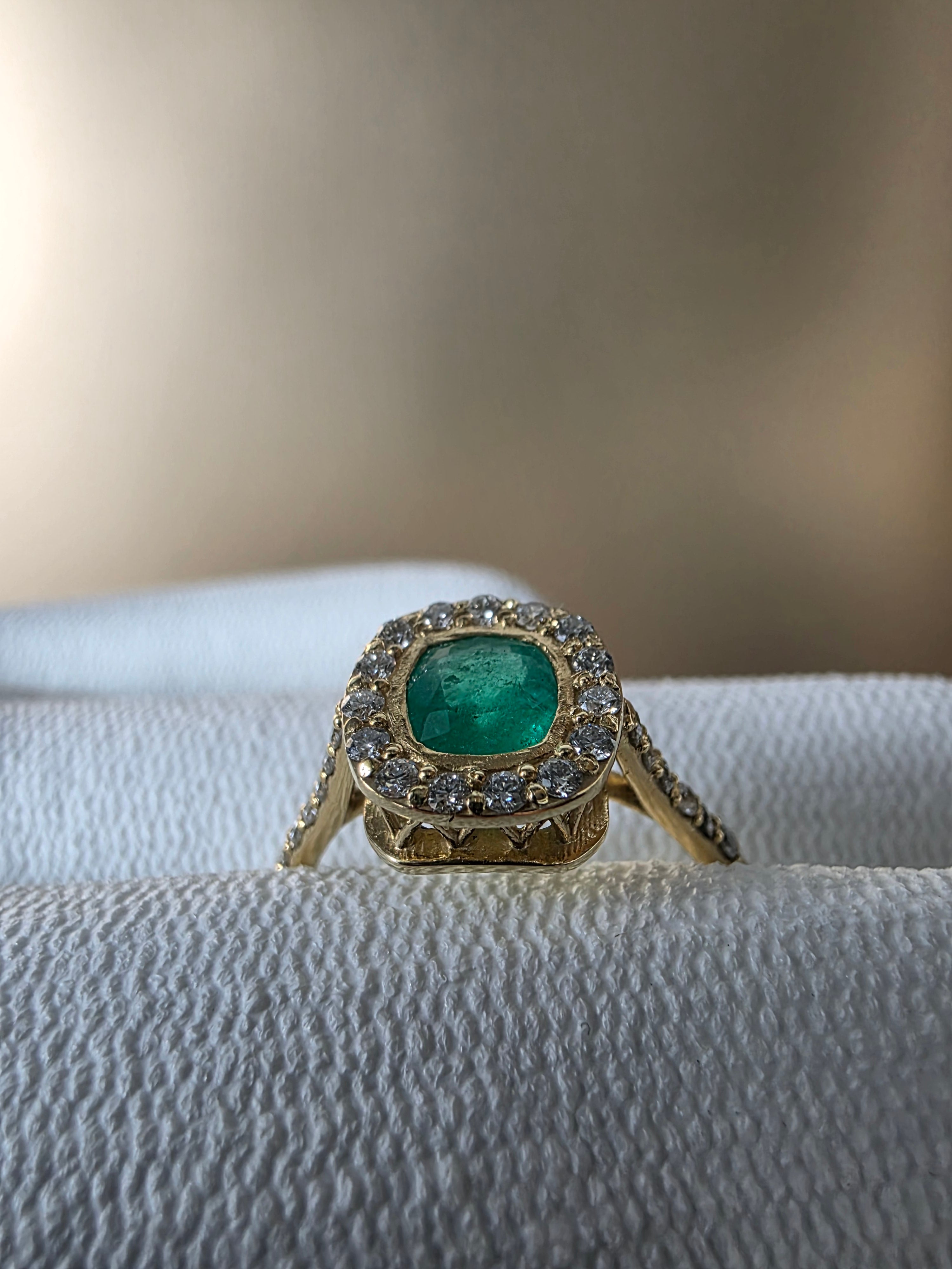 0.62 CT cushion Emerald with diamond halo ring