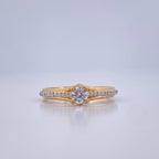 Gold ring with a diamond on a light gray background