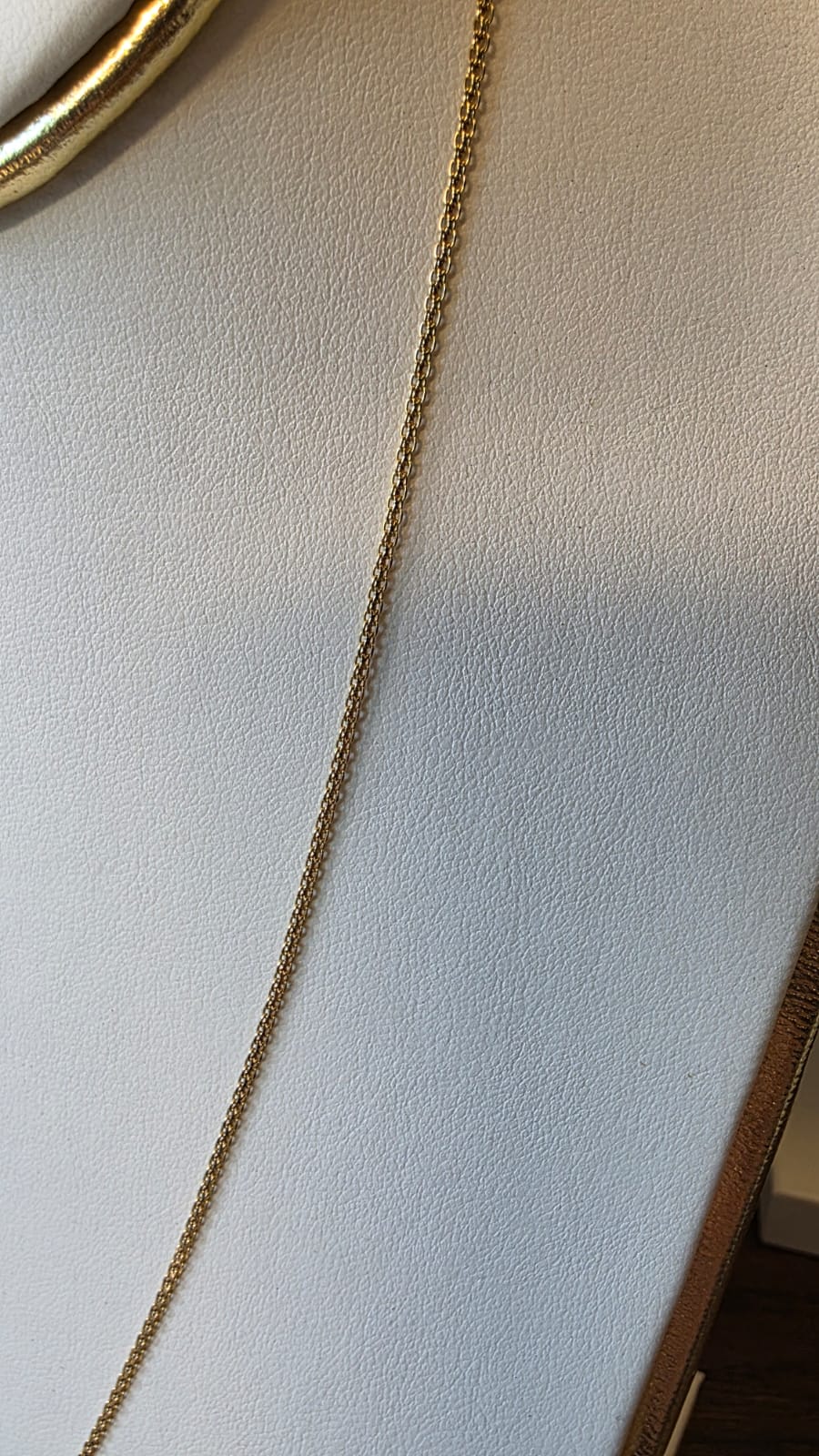 chino link chain in 18K solid gold, sclose up shot, on white necklace display | Gado Jewellers, Mississauga Ontario Fine Jewelry