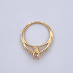 Gold ring with a diamond on a light gray background