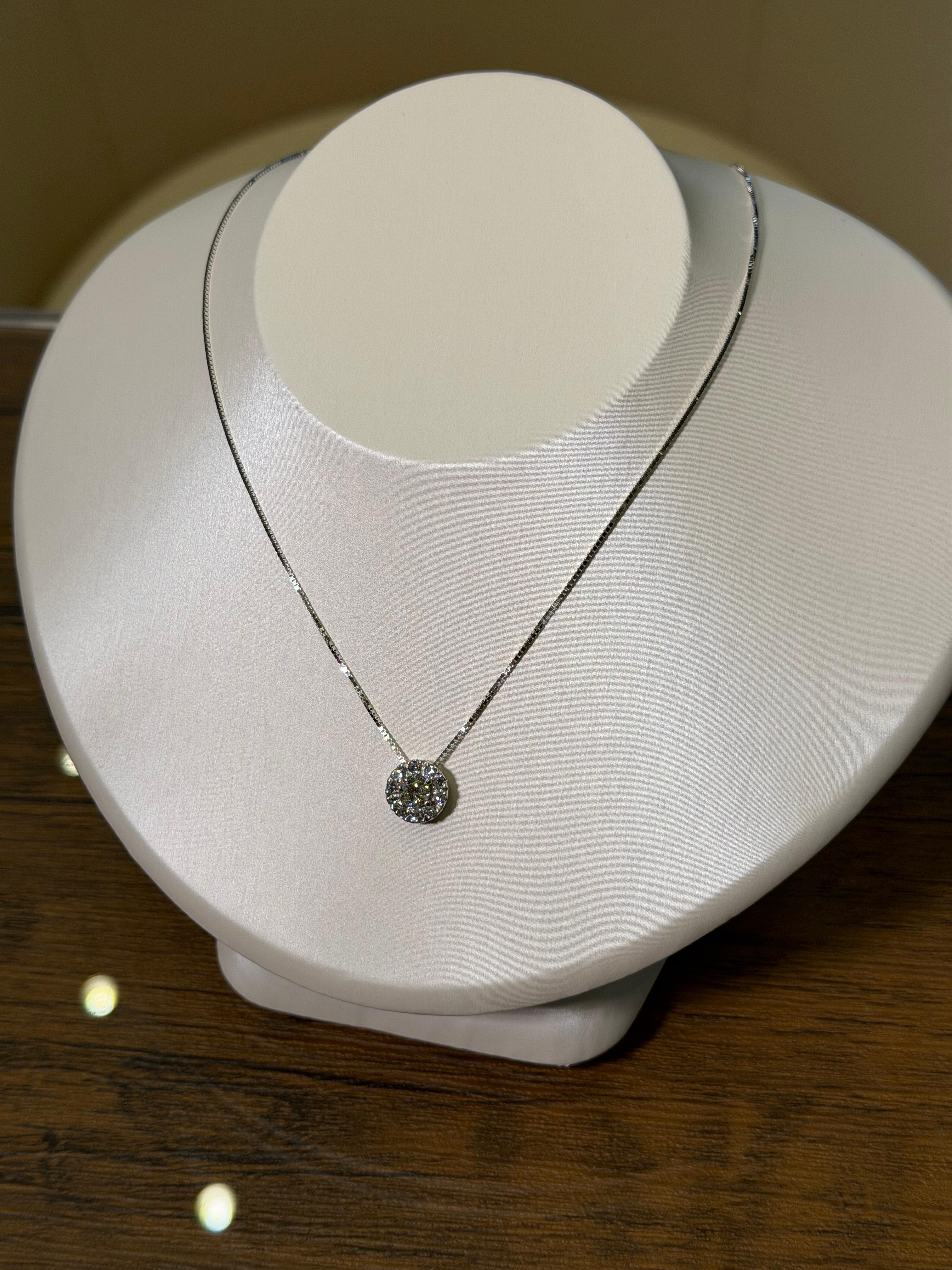 Necklace with a pendant on a white mannequin bust against a wooden background