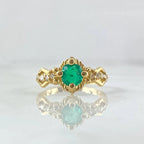 Round emerald engagement ring foundation with crown-style head and tapered diamond shoulders.