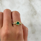 Round emerald engagement ring foundation with crown-style head and tapered diamond shoulders.
