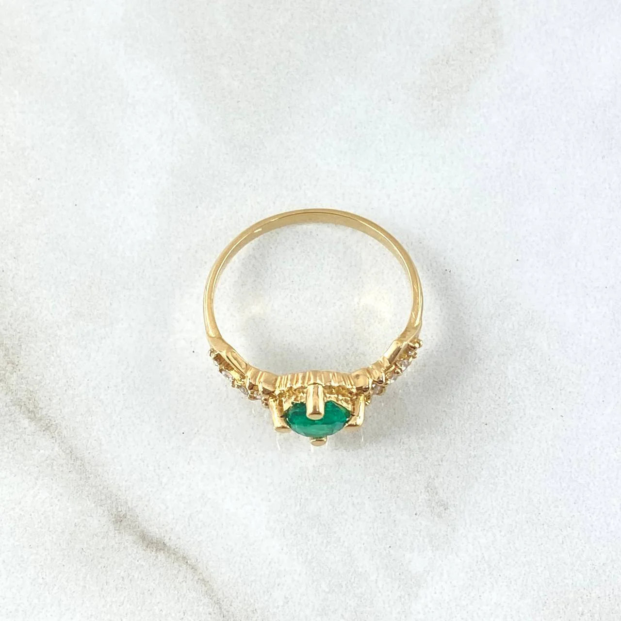 Round emerald engagement ring foundation with crown-style head and tapered diamond shoulders.
