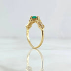 Round emerald engagement ring foundation with crown-style head and tapered diamond shoulders.