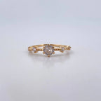Gold ring with diamonds on a light gray background
