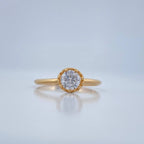 Gold ring with a diamond on a light blue background