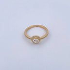 Gold ring with a diamond on a light gray background