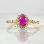 Gold ring with a pink diamond on a white background