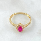 Gold ring with a pink diamond on a white background