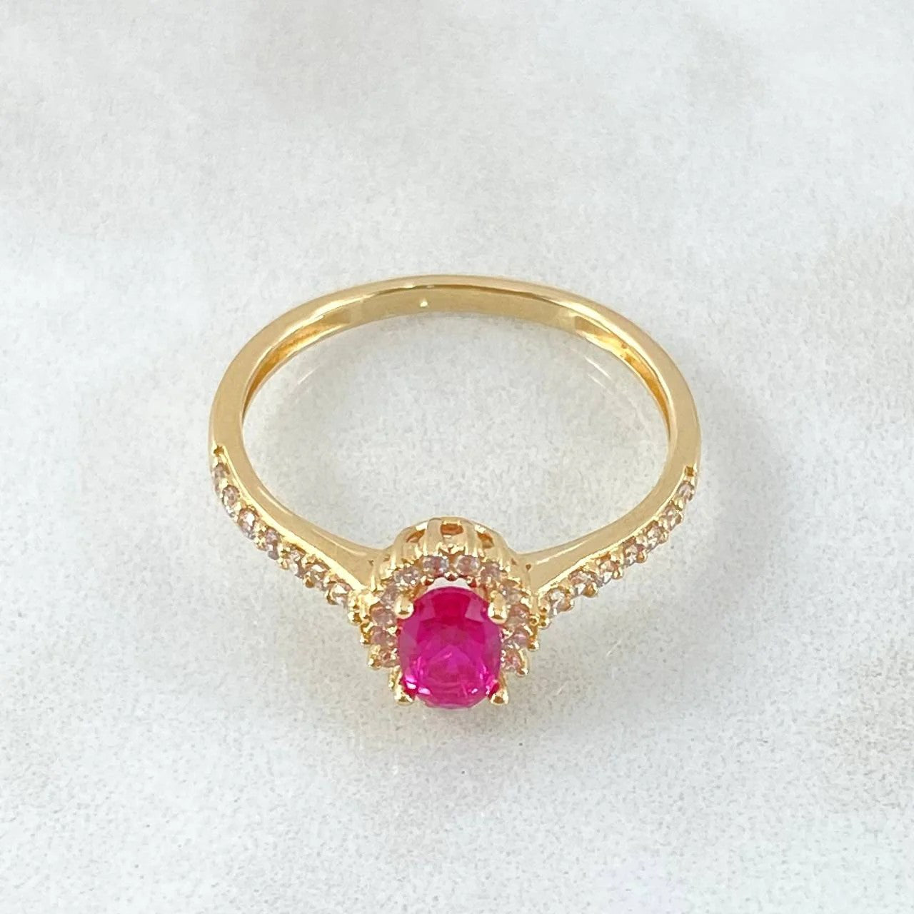 Gold ring with a pink diamond on a white background