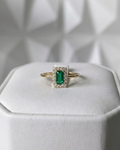 emerald cut Muzo emerald ring with diamond halo in 18K gold, displayed on ring box | Gado Jewellers, fine Canadian jewellery
