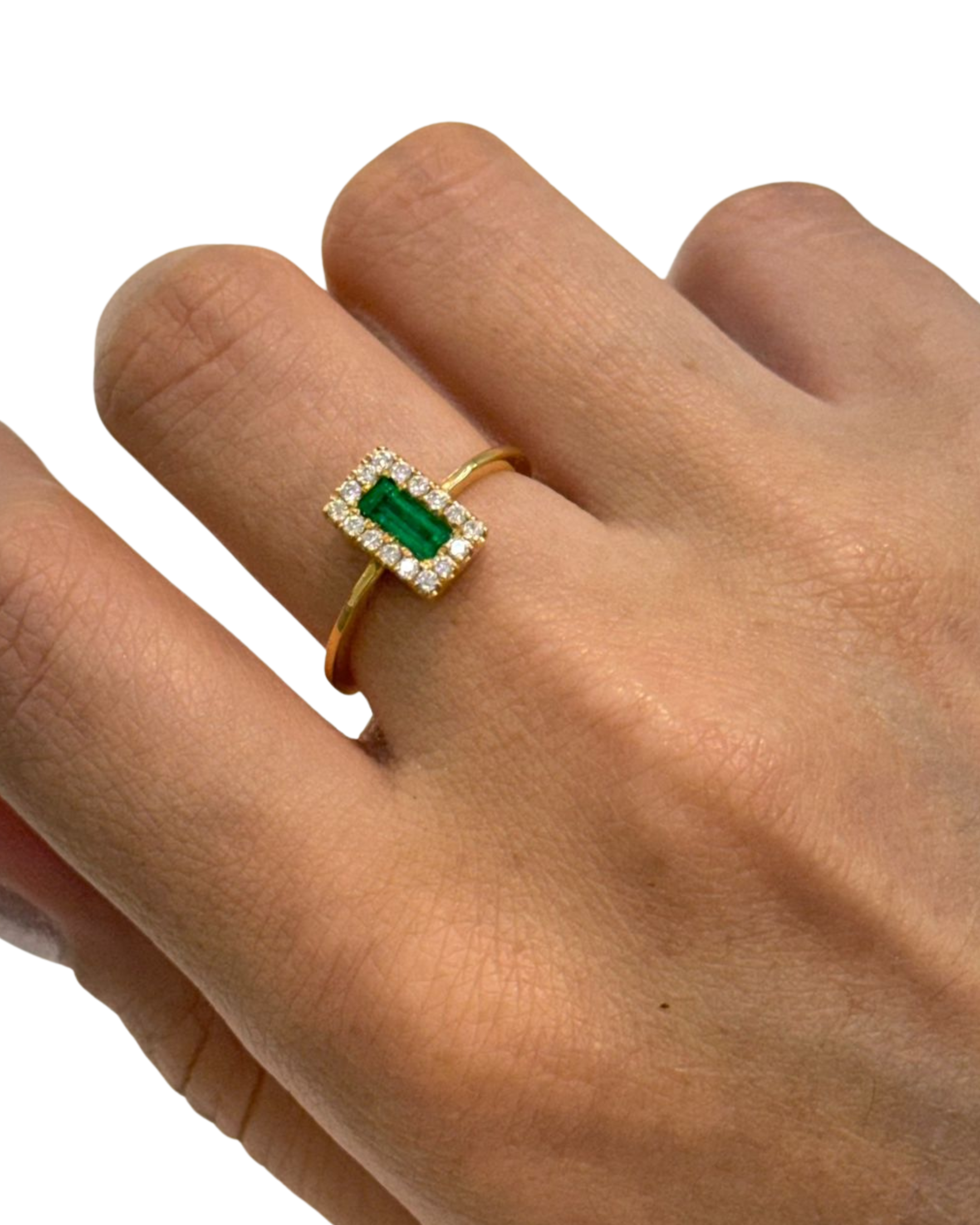 emerald cut Muzo emerald diamond halo ring in 18K gold worn on hand | Gado Jewellers, fine Canadian jewellery