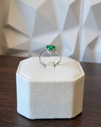 heart cut Colombian emerald diamond halo ring in white gold, close up on display stand | Gado Jewellers, fine Canadian jewellery
