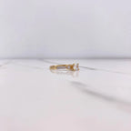 Gold ring with a diamond on a white background