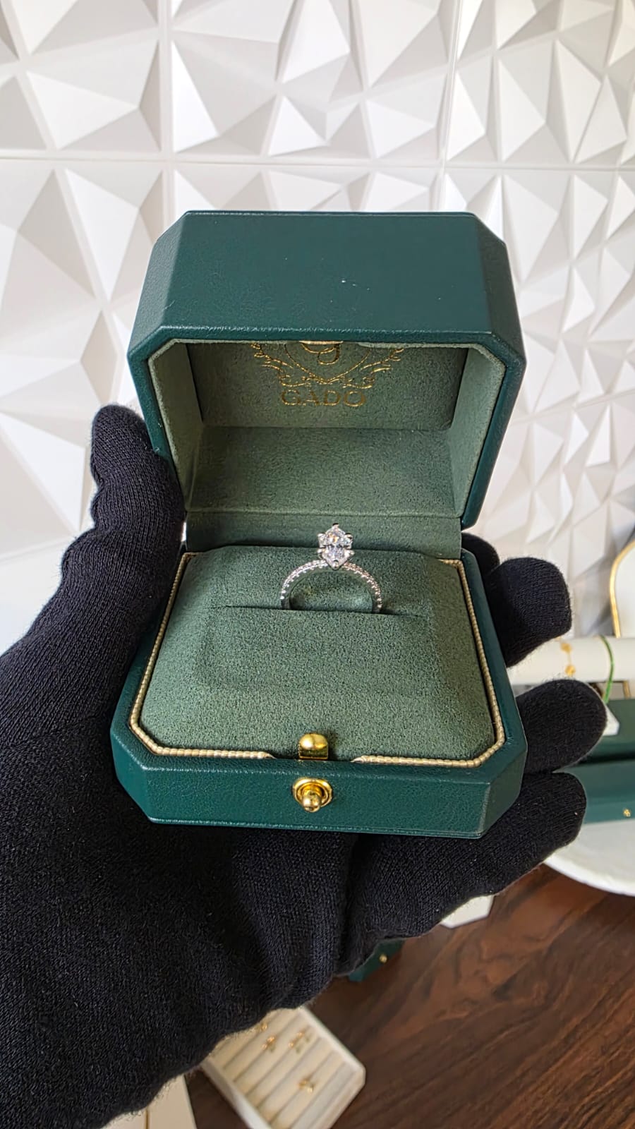 3ct marquise cut natural diamond engagement ring, prong set in white 18K gold, in a emerald green Gado jewellers box with a white background studio setting