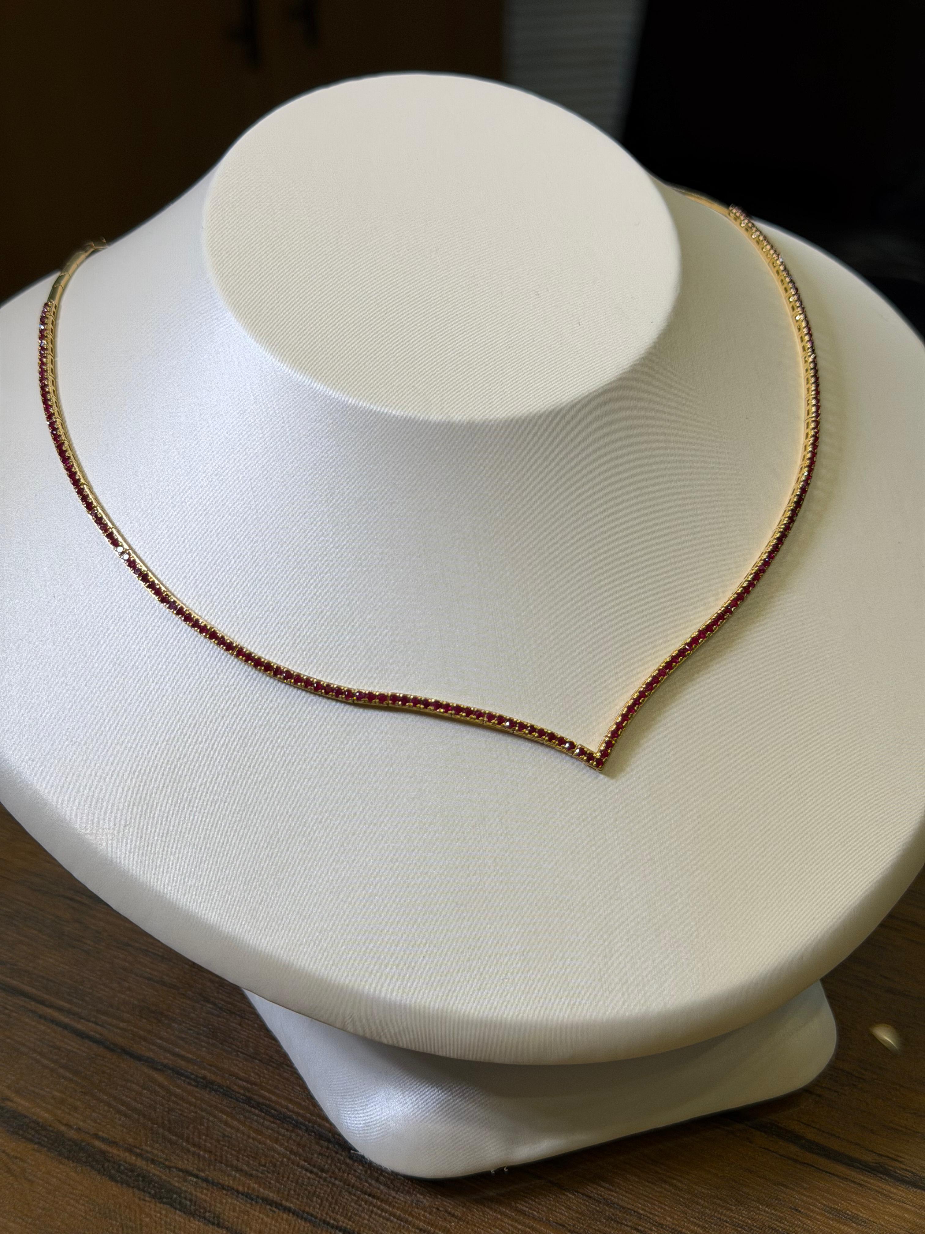 Necklace on a white mannequin bust with a dark background