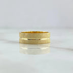 Brushed 18K gold wedding band with a continuous polished channel and rounded comfort profile.