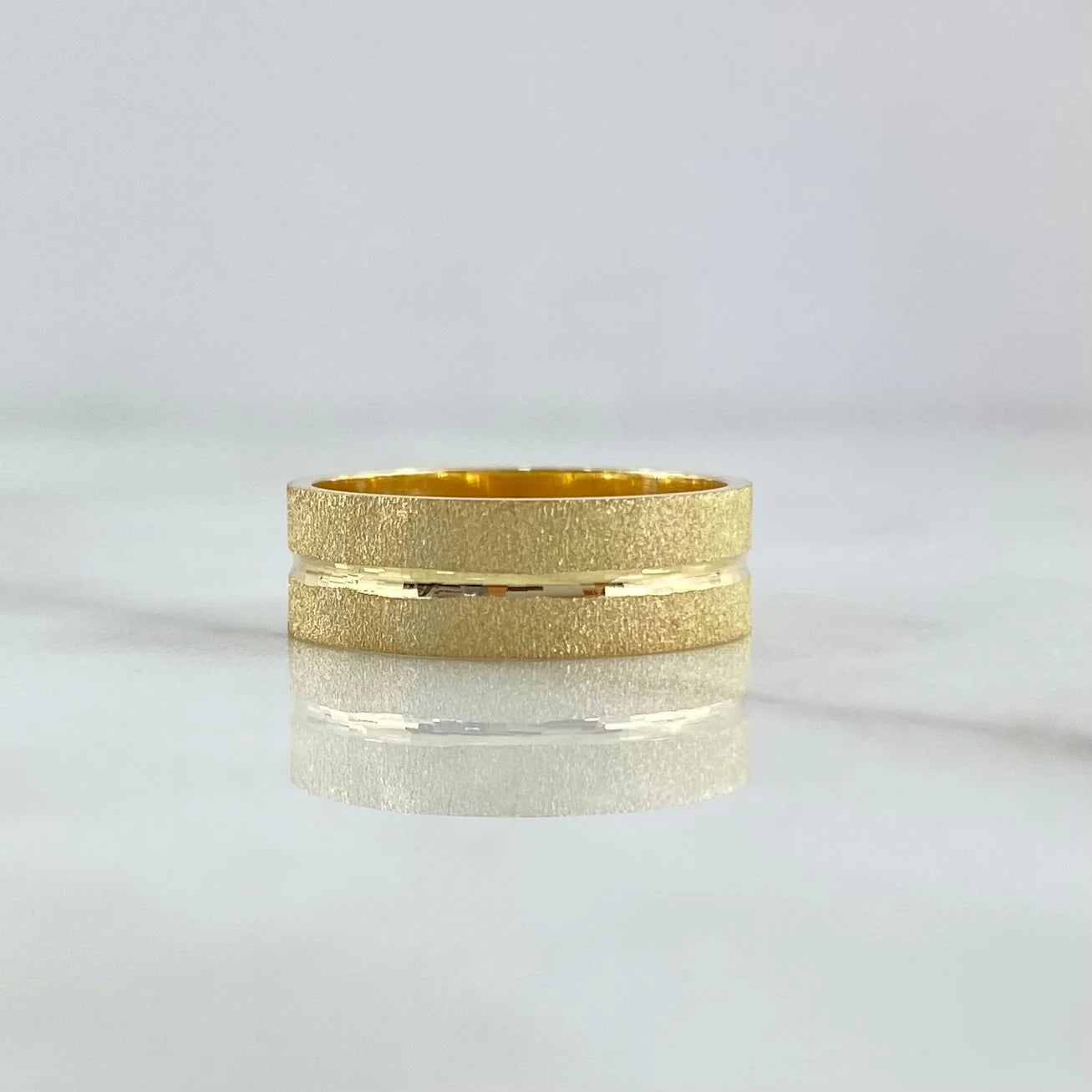 Brushed 18K gold wedding band with a continuous polished channel and rounded comfort profile.
