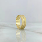 Brushed 18K gold wedding band with a continuous polished channel and rounded comfort profile.