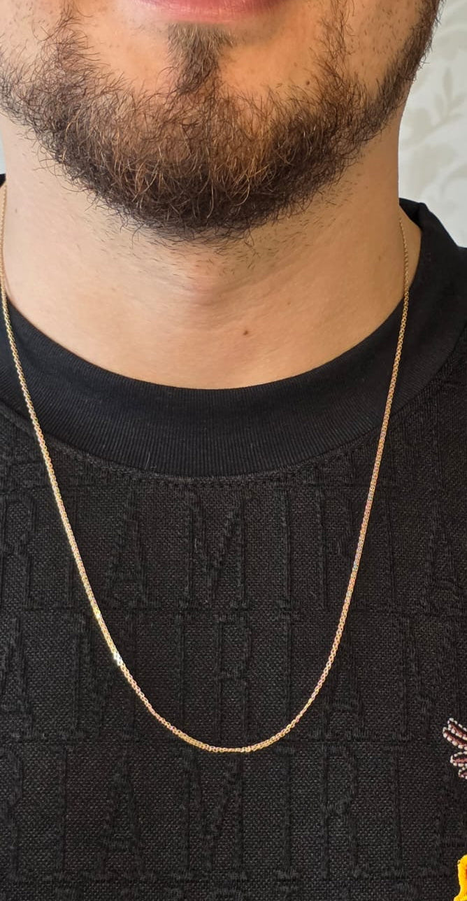 chino link chain in 18K solid gold, studio shot on male model with black textured shirt | Gado Jewellers, Mississauga Ontario Fine Jewelry