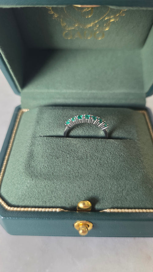 Colombian emerald band ring in 18K white gold, set in a Gado green ring box, styled studio shot | Gado Jewellers Mississauga Ontario Fine Jewellery