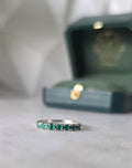 Close-up of Colombian emerald stone and setting on band ring in 18K white gold | Gado Jewellers Fine Jewelry