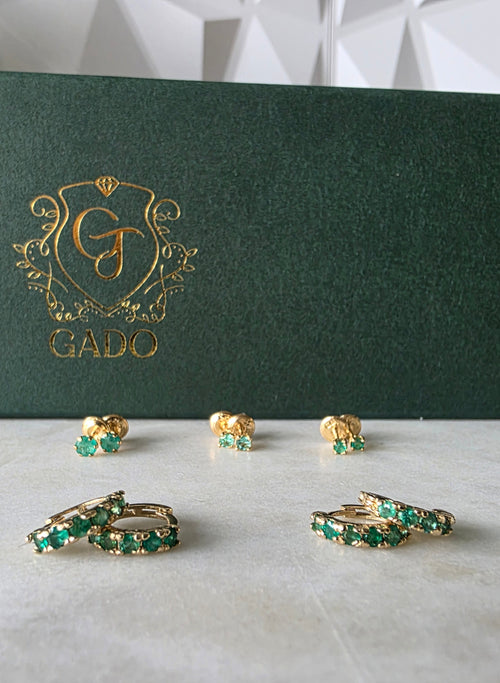 Colombian emerald huggie hoop earrings in 18K gold, studio shot