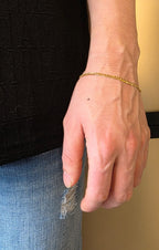 Cuban curb link bracelet in 18K gold worn on wrist | Gado Jewellers Fine Jewellery Mississauga
