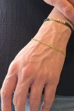 Cuban curb link bracelet in 18K gold worn on wrist | Gado Jewellers Fine Jewellery Mississauga