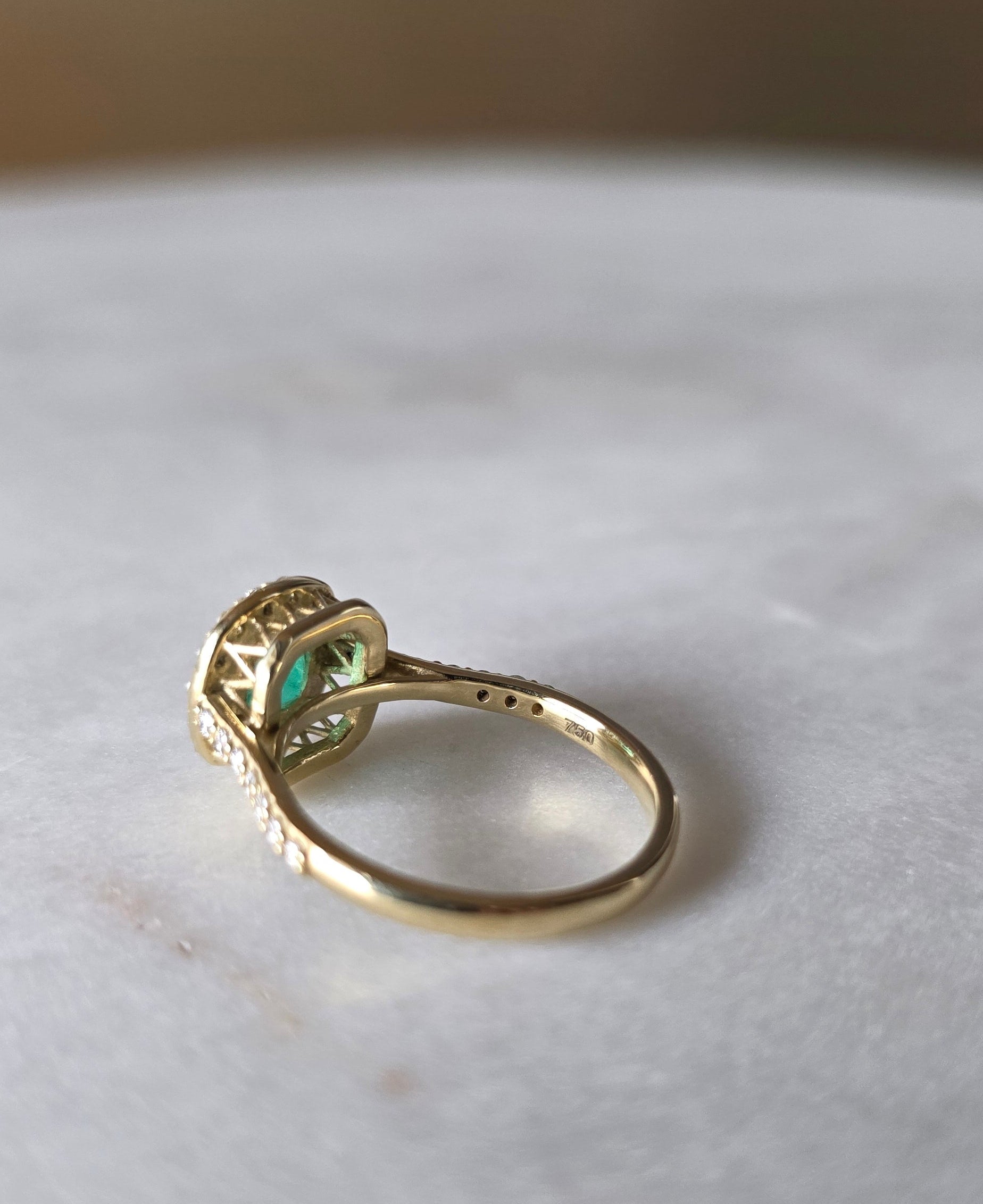 cushion cut natural colombian emerald center stone, natural diamond halo, engagement ring in 18K yellow gold, studio shot in signature Gado packaging, fully certified gemstones and gold purity | Gado Jewellers Canadian Fine Jewelry Jewellery Custom Engagement Rings
