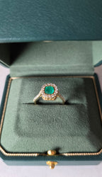 cushion cut natural colombian emerald center stone, natural diamond halo, engagement ring in 18K yellow gold, studio shot in signature Gado packaging, fully certified gemstones and gold purity | Gado Jewellers Canadian Fine Jewelry Jewellery Custom Engagement Rings
