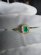 cushion cut natural colombian emerald center stone, natural diamond halo, engagement ring in 18K yellow gold, studio shot in signature Gado packaging, fully certified gemstones and gold purity | Gado Jewellers Toronto Fine Jewelry Custom Engagement Rings