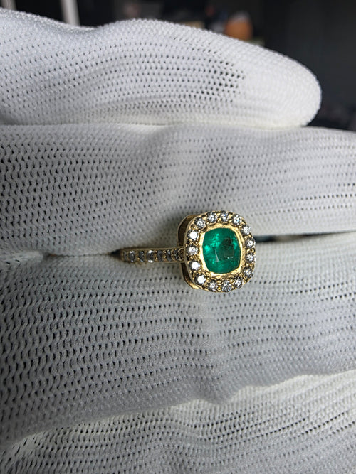 cushion cut natural colombian emerald center stone, natural diamond halo, engagement ring in 18K yellow gold, studio shot in signature Gado packaging, fully certified gemstones and gold purity | Gado Jewellers Toronto Fine Jewelry Custom Engagement Rings