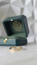 Close-up of back of emerald ring setting on chevron styled band, in 18K gold | Gado Jewellers Fine Jewellery 