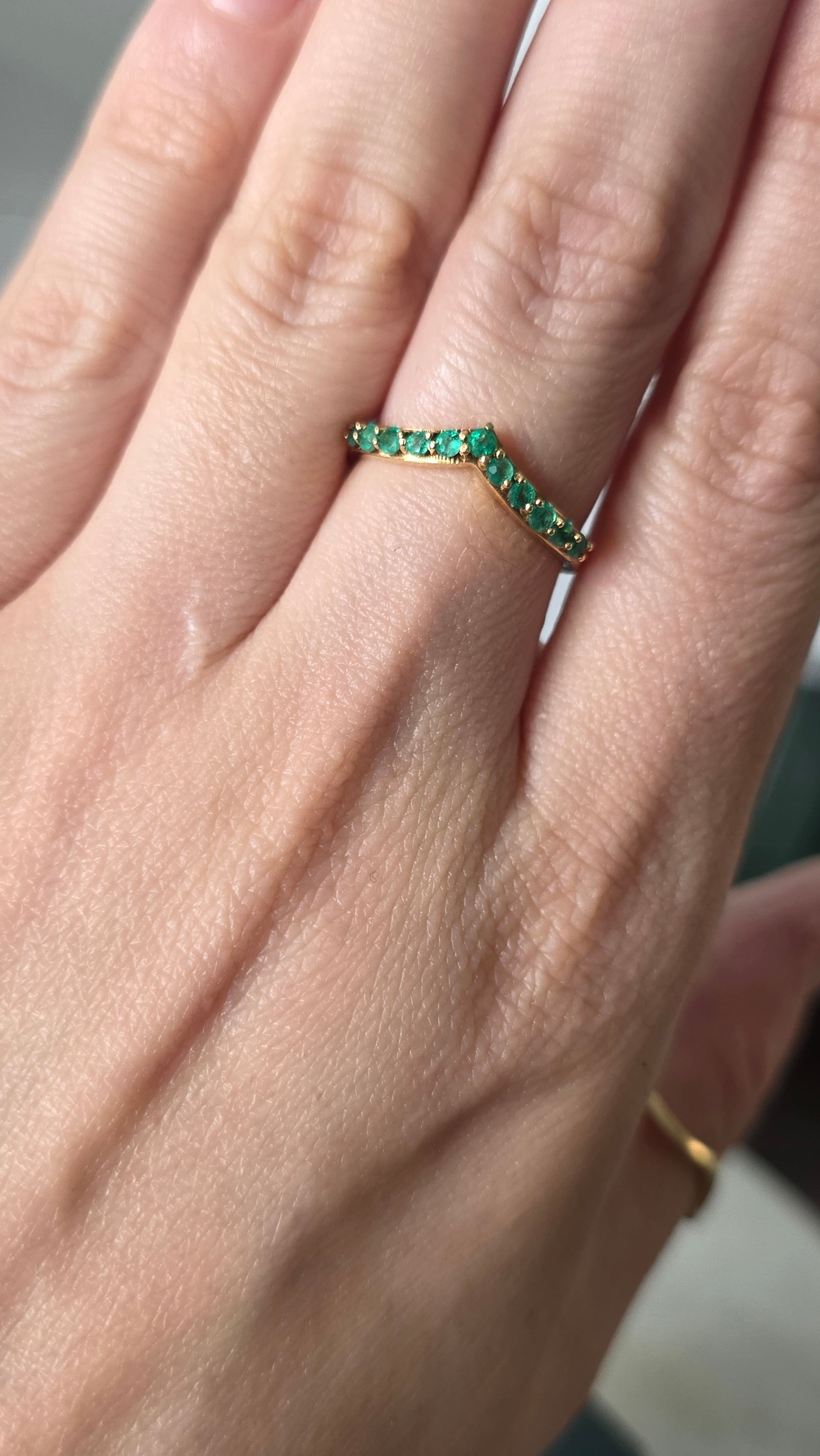 emerald chevron ring in 18K gold worn on hand | Gado Jewellers Fine Jewellery 