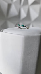 Natural Colombian emerald band ring on display stand, 18K Italian white gold, Gado Jewellers