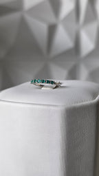 Natural Colombian emerald band ring on display stand, 18K Italian white gold, Gado Jewellers