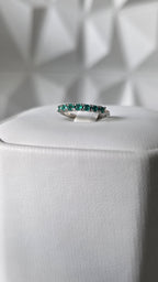 Natural Colombian emerald band ring on display stand, 18K Italian white gold, Gado Jewellers