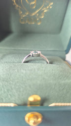 Colombian emerald halo ring in Gado green jewelry box, 18K white gold