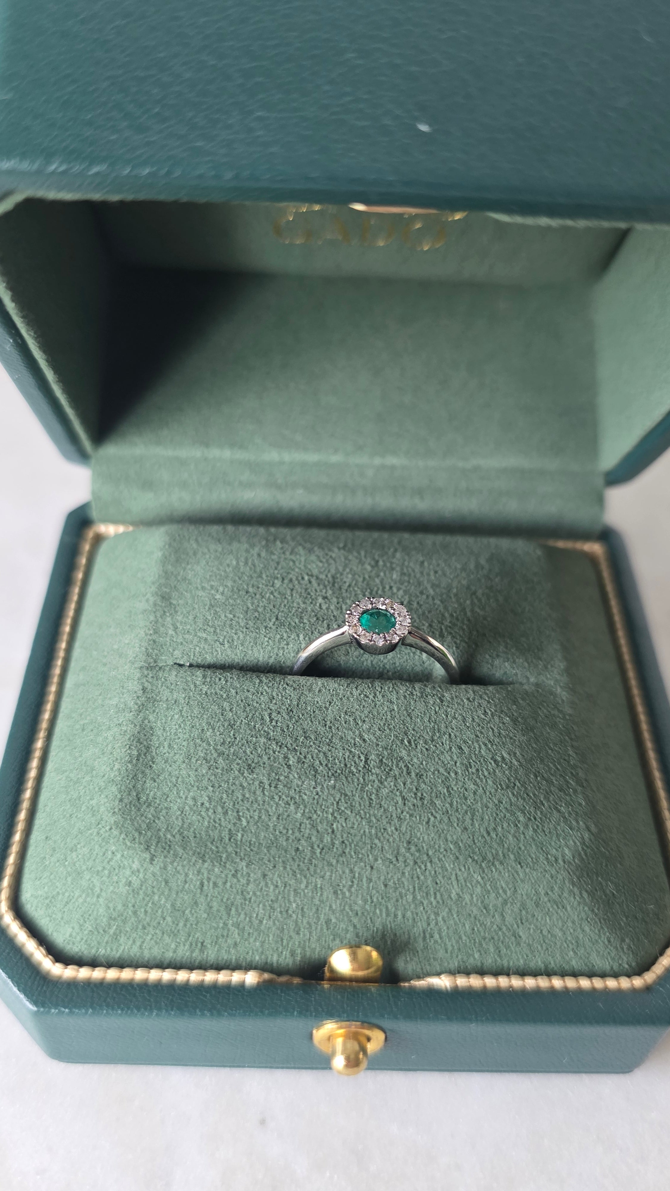 Colombian emerald halo ring in Gado green jewelry box, 18K white gold