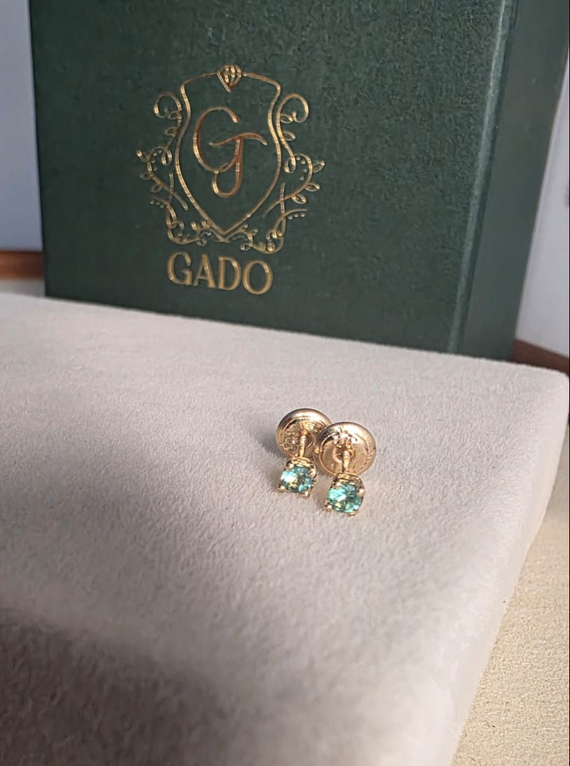 natural Colombian emerald stud earrings in 18K gold, studio shot | Gado Jewellers Fine Jewelry Canada Custom Designs