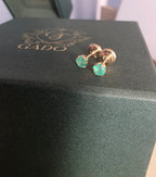 natural Colombian emerald stud earrings in 18K gold, studio shot | Gado Jewellers Canadas Haus of Emeralds Fine Jewelry