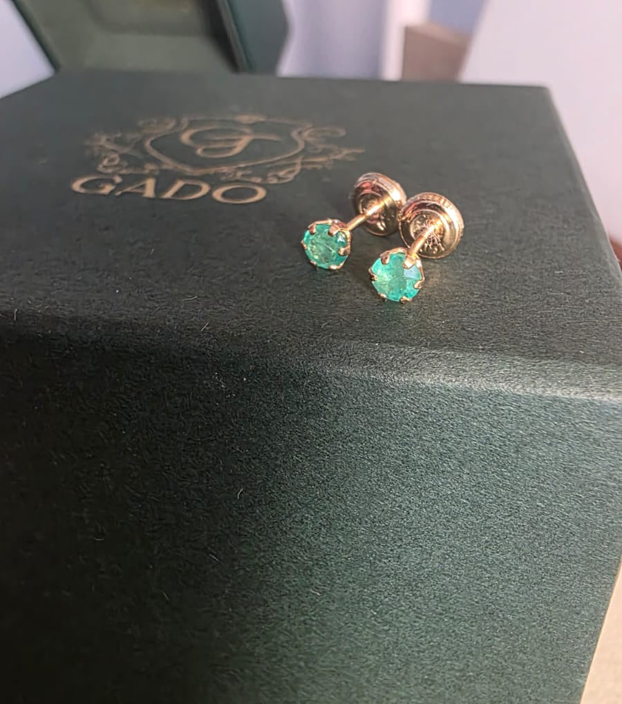 natural Colombian emerald stud earrings in 18K gold, studio shot | Gado Jewellers Canadas Haus of Emeralds Fine Jewelry